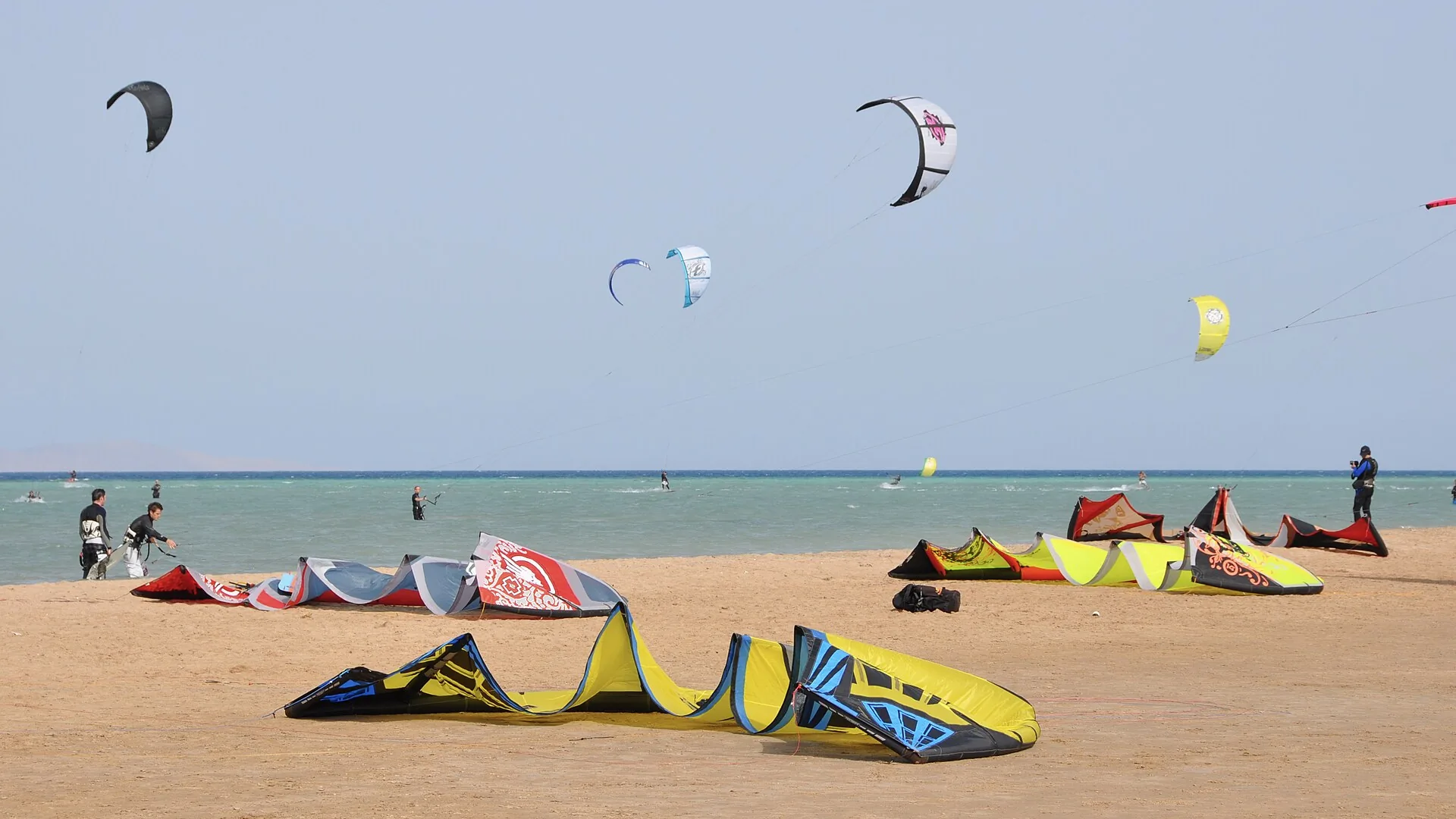 Kites on the sand and riders on the water at Mangroovy Beach, El Gouna, on the Red Sea
