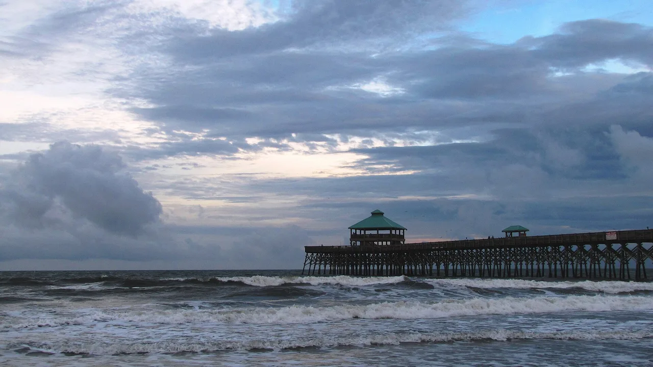 Waves breaking near Folly Beach Pier at dusk, Folly Beach, South Carolina