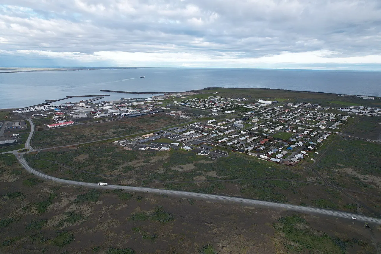Aerial view of Þorlákshöfn, its harbour breakwaters and the open Atlantic beyond the town