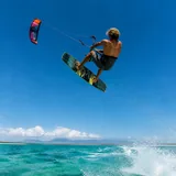 Kitesurfer performing a jump in strong wind