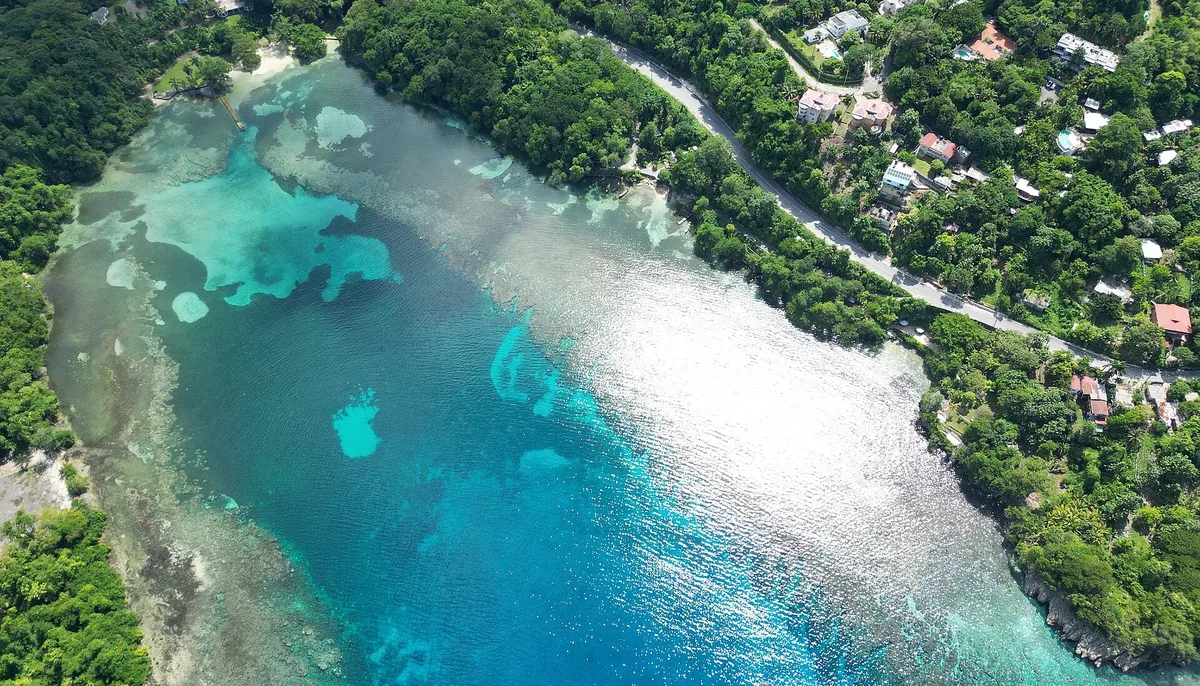 Aerial view of San San Bay near Port Antonio, Portland, Jamaica, with reef showing through clear turquoise water
