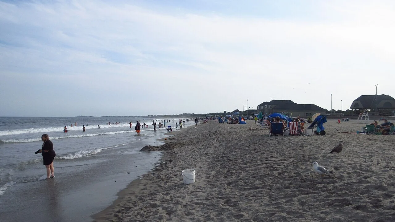 Scarborough State Beach, Narragansett, Rhode Island, with the beach pavilion and swimmers in the shorebreak
