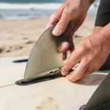 Adjusting a surfboard fin with a tool