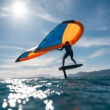 Wing foil rider flying above the water